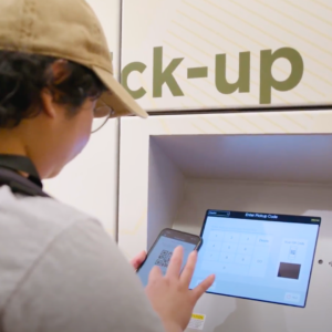 Person picking up order from food pickup lockers using mobile app