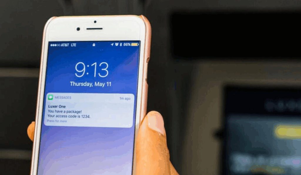 Resident using the Luxer One mobile app notifications on their phone to open the smart locker