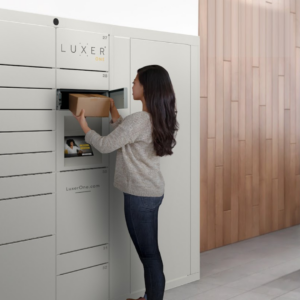 Woman removing package from grey Luxer One smart package lockers