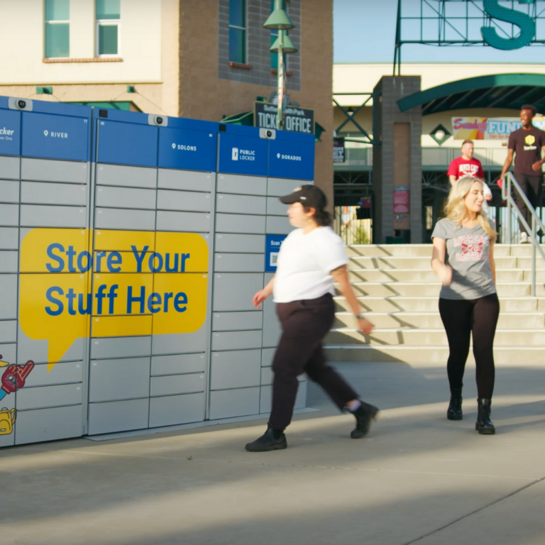 Attendee picking up items from bag storage lockers outside of venue