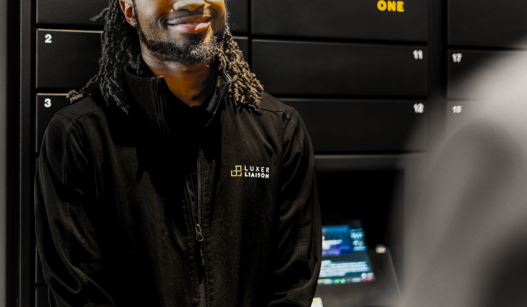Luxer Liaison standing in front of black Luxer One package lockers
