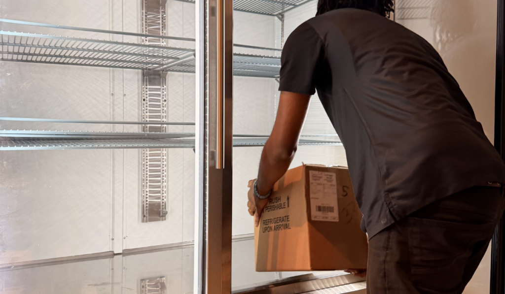 Luxer Liaison placing package in refrigerator in smart package room