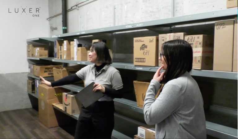 Luxer Liaison assisting a resident finding a package in the smart package room