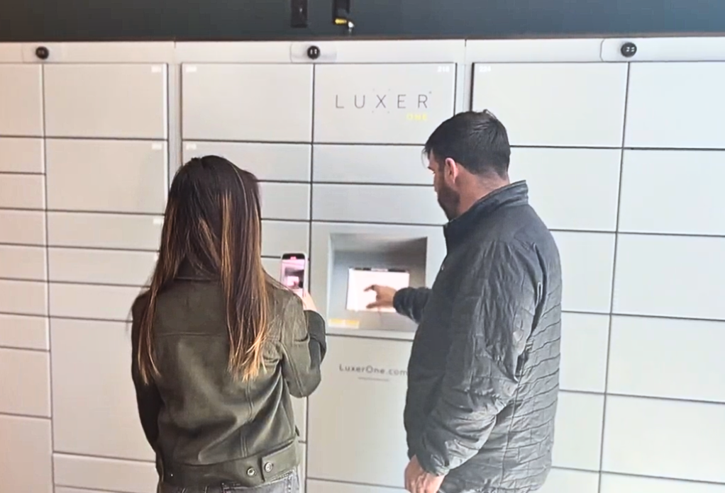 Luxer One employees supporting a property manager to educate them on their Luxer One locker system
