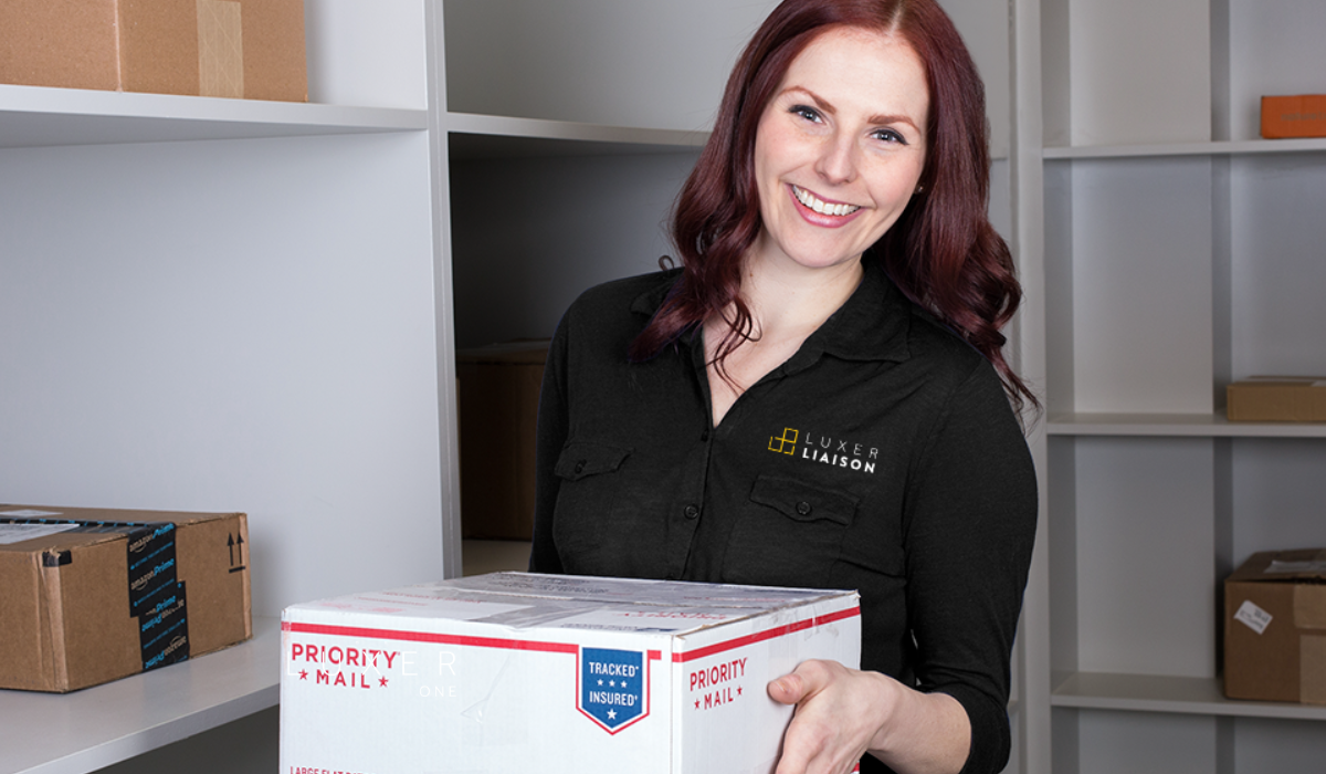 On-site package concierge, Luxer Liaison holding a package in a clean package room