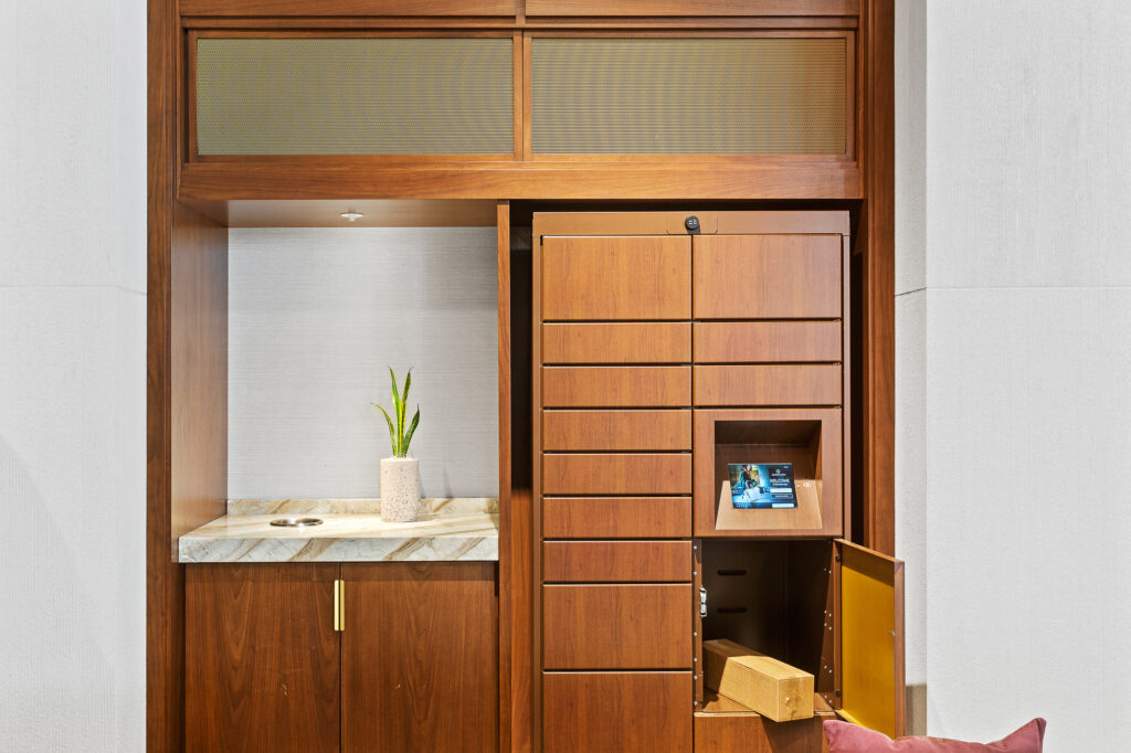 Wooden wrapped smart lockers with door open revealing package inside