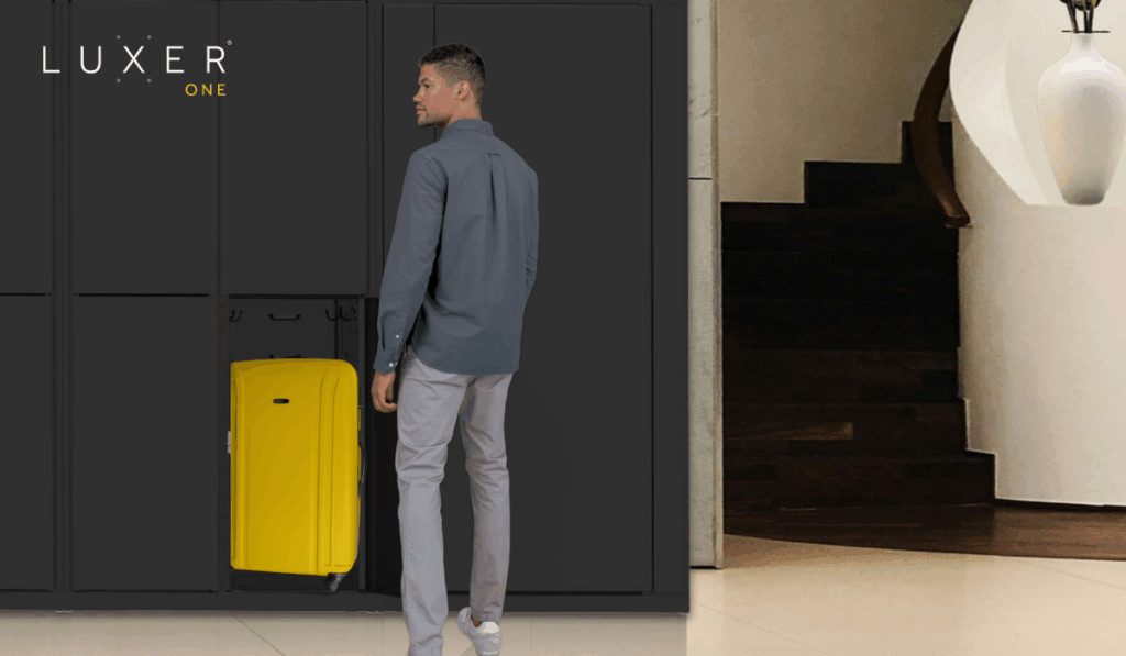 Hotel guest picking up luggage from storage lockers in lobby