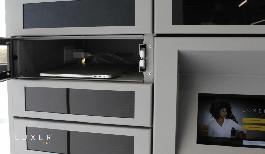 Asset management lockers with door open showing laptop charging inside