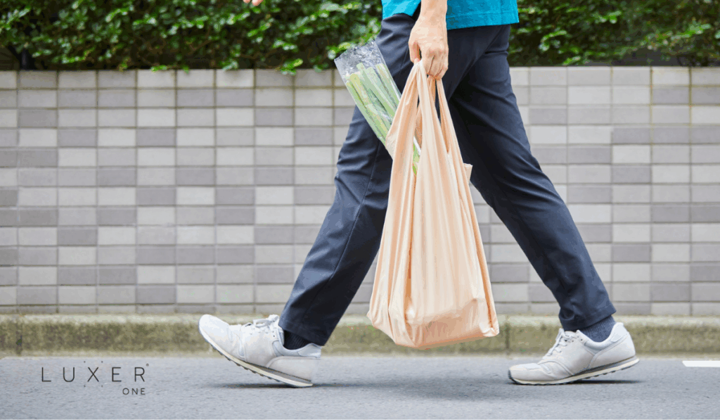 Third-Party delivery driver carrying grocery bag to customer