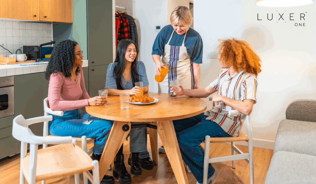 Happy residents eating breakfast at kitchen table