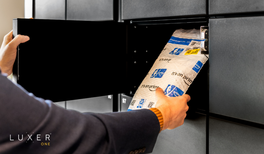 Person getting their Amazon delivery from black smart package lockers