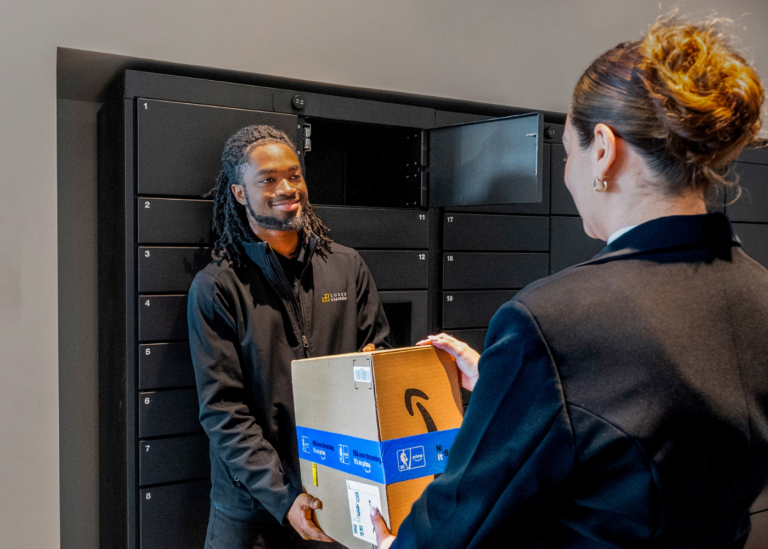 Luxer Liaison handing package to resident at 704 at the Quarter in Charlotte, NC